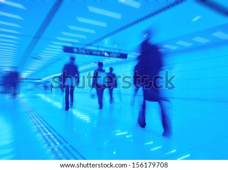 clean tiled floor, reflection of light on floor and blurred view of people walking