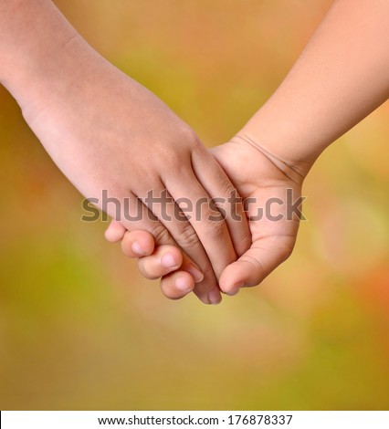 Close up of two young girls holding hands
