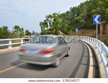 Traffic concept: car driving fast through a sharp turn