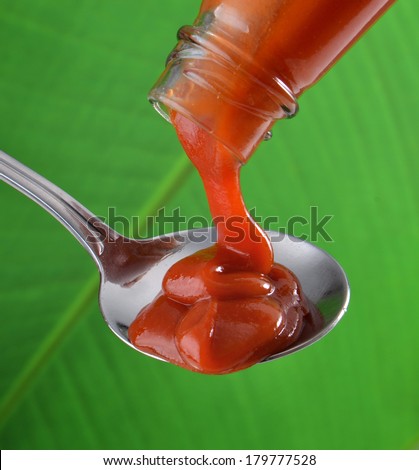 Hot Chili Sauce Pouring from Bottle