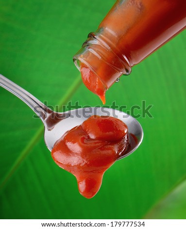 Hot Chili Sauce Pouring from Bottle