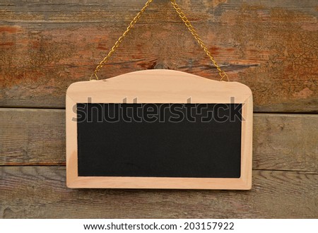 Small school wooden blank blackboard isolated on wood background