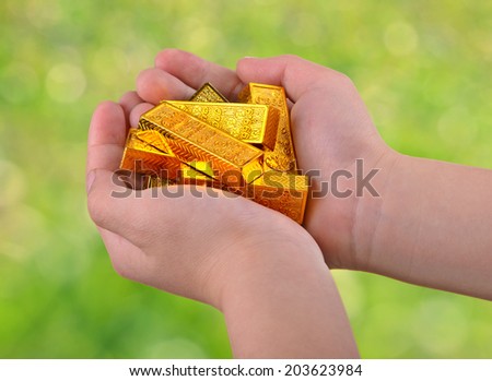 Gold ingots in hands