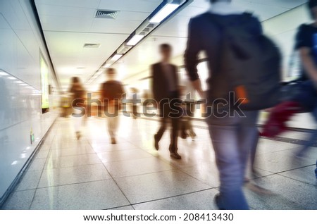 Crowd inside subway train station in motion blur abstract effect