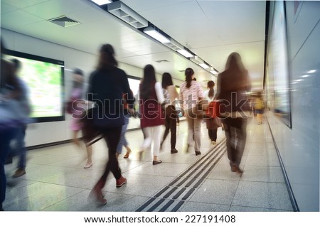 Passengers in a hurry to walk the modern subway station tunnels