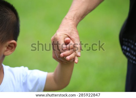 Child and grandma holding hands