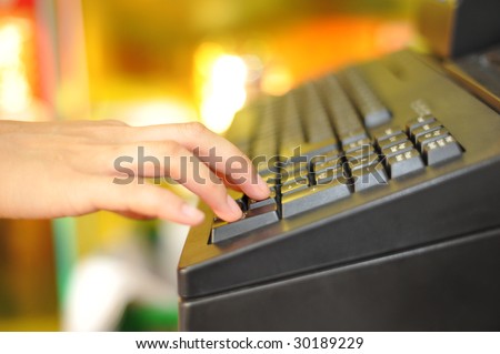 Woman\'s hand on cash register buttons