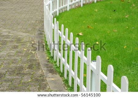 White fence around front yard of residential house