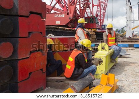 THAILAND NOVEMBER 14,2012: Construction workers on break during moment of silence
