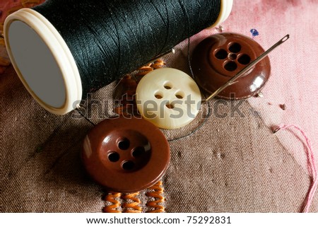 Handicraft fittings like needles, thread, buttons and pincushion