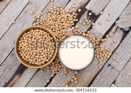 top view of soy milk and soy beans with wood background