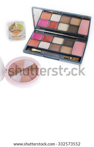 makeup palette and highlighter on white background