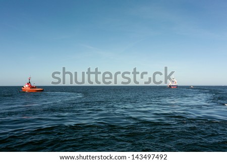 Tugs and vessel. Exit port.
