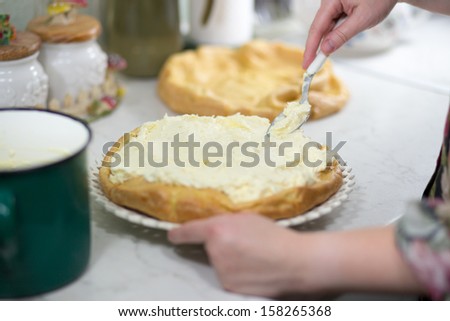 In the Polish kitchen. Preparing a delicious Karpatka cake. Polish Carpathian Mountain cream cake is made with puff pastry.