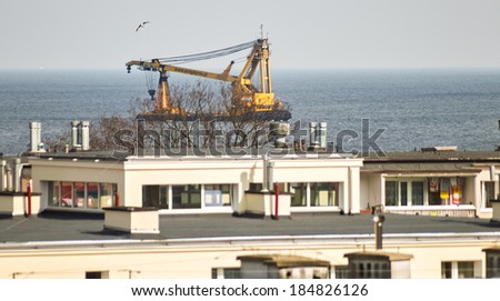 GDANSK BRZEZNO, POLAND - MARCH 21, 2014: Beautiful view from the window of the Gulf of Gdansk. In the background, vessels in Reda and Crane Maja a port of Gdansk.