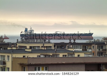 GDANSK BRZEZNO, POLAND - MARCH 27, 2014: Beautiful view from the window of the Gulf of Gdansk. On the photo, vessel OSG COMPANY calling at a port of Gdansk.