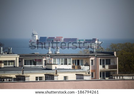 GDANSK BRZEZNO, POLAND - APRIL 11, 2014: Beautiful view from the window of the Gulf of Gdansk. On the photo, container vessel HENNEKE RAMBOW calling at a port of Gdansk.