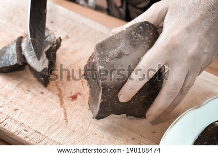 In Polish cuisine, on the Polish table. Preparation of Liver pate. On the picture cutting of pig liver.