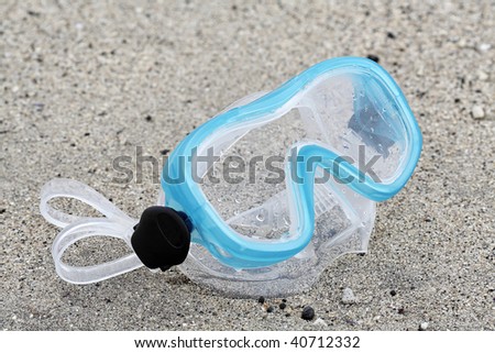 blue Children diving mask on white sand on beach in summer
