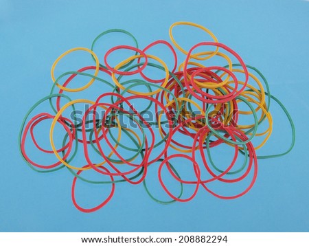 Close up of colourful rubber bands on a blue background