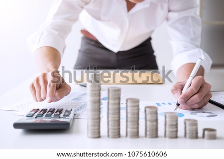 Business accountant or banker, businessman calculate and analysis with stock financial indices and putting growth stacking coin and financial costs wisely and carefully, investment and saving concept.