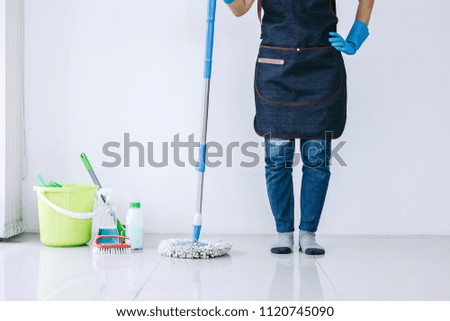 Premium Photo  Wife housekeeping and cleaning concept, happy young woman  in blue rubber gloves wiping dust using a spray and a duster while cleaning  on floor at home