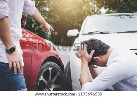 Two drivers man arguing after a car traffic accident collision, Traffic Accident and insurance concept.