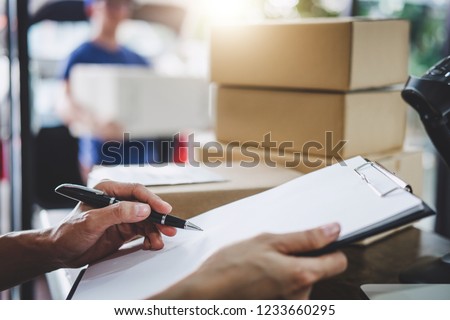 Home delivery service and working service mind, Woman working checking order to confirm before sending customer in post office.