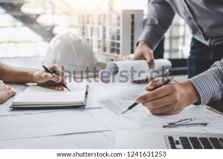 Construction and structure concept of Engineer or architect meeting for project working with partner and engineering tools on model building and blueprint in working site.