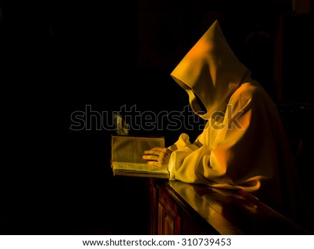 Monk reading the Bible in a nice evening light