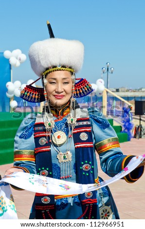 ULAN-UDE, RUSSIA - SEPTEMBER 15: Cultural program of Baltic Economic Forum. An unidentified woman in national dress Buryat greets guests of festival., September 15, 2012 in Ulan-Ude, Buryatia, Russia