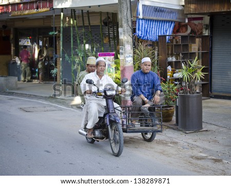 PHUKET, THAILAND - MAY 12: Members of the Muslim community in Thailand returning from prayers. On may 12, 2013 in Phuket, Thailand. Three percent of population of Thailand - Muslims.
