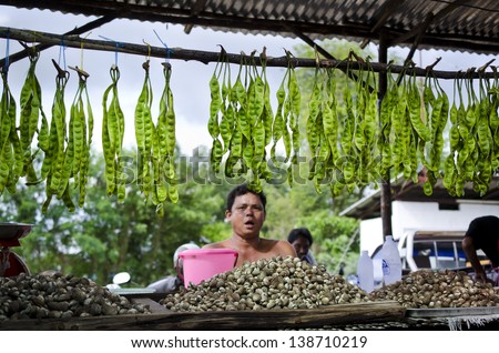 PHUKET, THAILAND - MAY1: Food market. A man sells edible molluscs and beans on may 1, 2013 in Phuket, Thailand.