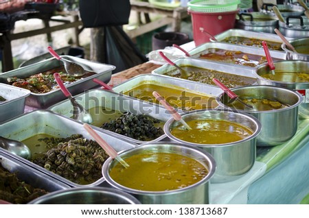 Food market in Phuket, Thailand. Traditional Thai soups in the pans.
