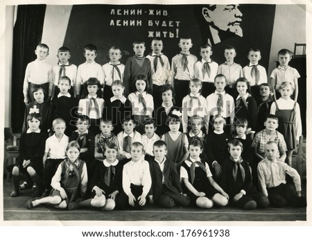 KURSK, USSR - CIRCA 1970:  An antique photo shows group  portrait of school graduates. Russian text: Lenin lived, Lenin lives, Lenin will live.