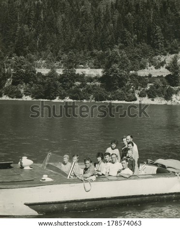 SUDAK, UKRAINE, USSR - CIRCA 1970s : An antique photo shows group of Russian tourists boating. \