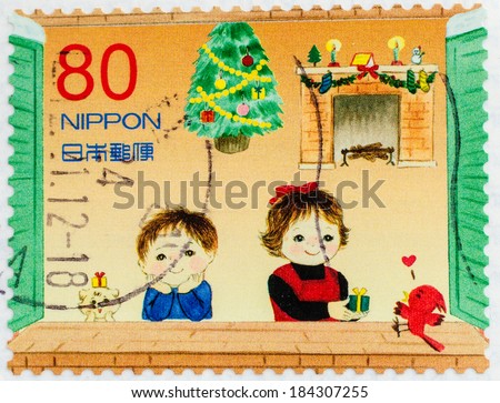 JAPAN - CIRCA 1990th: A stamp printed in Japan, shows children at Christmas tree, circa 1990th