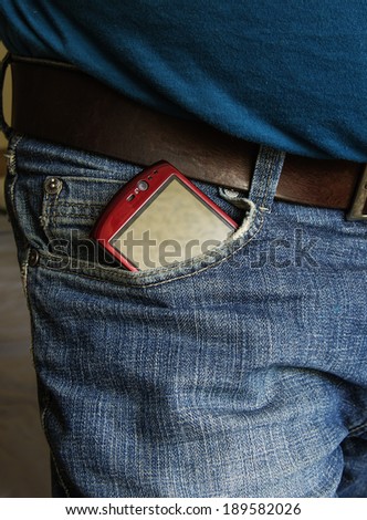 Smartphone with blank screen sticking out of the back pocket in a  jeans, clipping path for the screen to add your own text.
