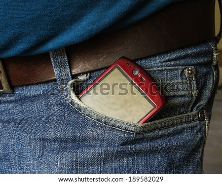 Smartphone with blank screen sticking out of the back pocket in a  jeans, clipping path for the screen to add your own text.