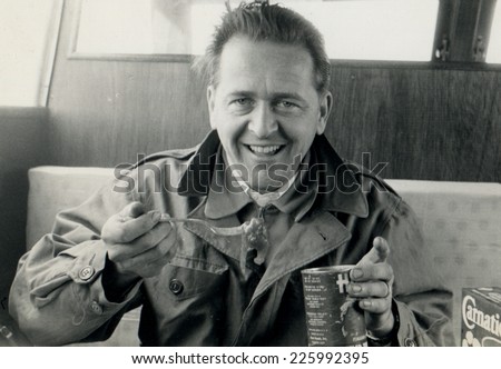 ITALY - CIRCA 1970s: Vintage photo shows man eating canned food.