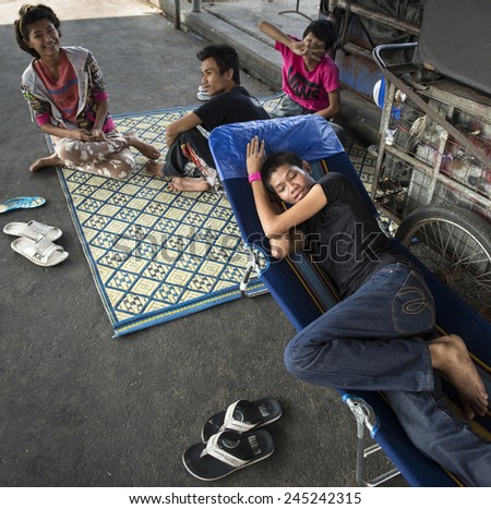 BANGKOK, THAILAND - DECEMBER 25, 2014: Street Photography of homeless refugees from Cambodia.