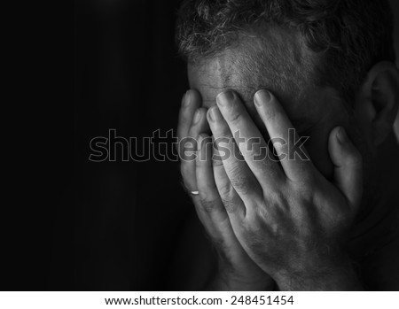Man in depression, \
hands covered his face