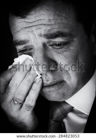 Crying businessman. Black and white portrait