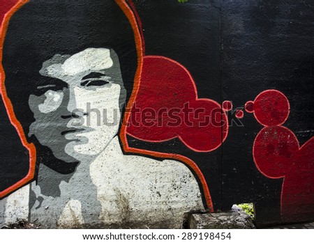 MOSCOW - JUNE 21, 2015: Graffiti on a urban wall (near B. Novodmitrovskaya street). Bruce Lee portrait