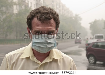 Smog in the city. A men in medical mask