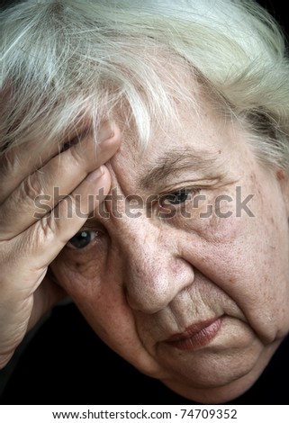Old woman, absorbed in sad thoughts