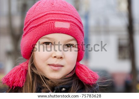smiling girl in a red knit cap