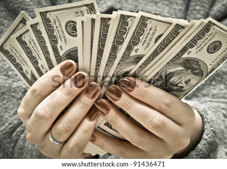 stock-photo-woman-s-hand-recount-bundle-of-dollars-91436471.jpg