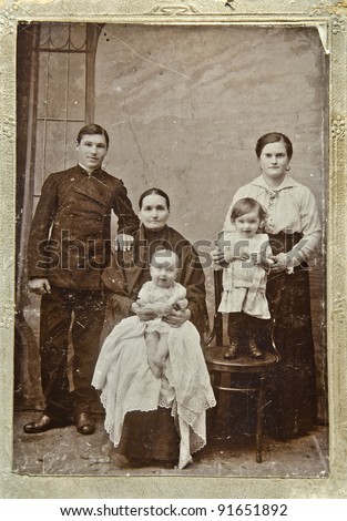 RUSSIA - CIRCA 1903: Old photo printed in Russia shows family: grandmother, mother, father, two children, circa 1903