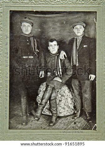 RUSSIA - CIRCA 1931: Old photo printed in Russia shows three young men from Siberia, circa 1931